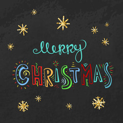 Merry Christmas card with childish style freehand lettering at black chalkboard and golden foil snowflakes.