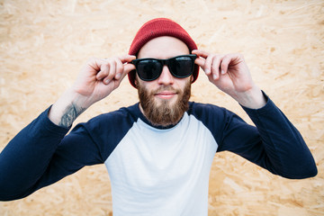 white blank t-shirt with space for your logo on a hipster man wi