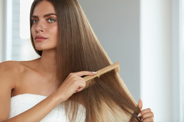 Brushing Hair. Woman Hairbrushing Beautiful Long Hair With Comb - obrazy, fototapety, plakaty