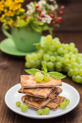 Sultan Grapes on a wooden background. Close-up. Selective focus