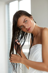 Hair Care. Beautiful Woman With Wet Hair In Towel After Bath