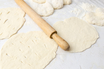 rolling dough with a rolling pin