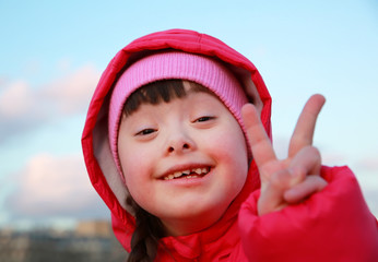 Young girl smiling on background of the blue sky