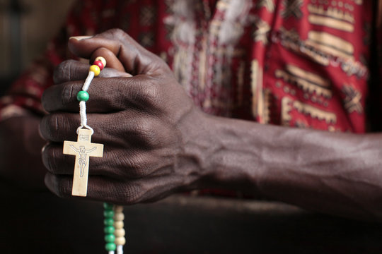 African man praying the rosary, Cotonou, Benin, West Africa