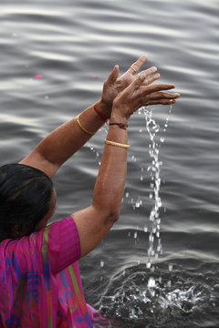 Hindu woman praying in the Yamuna River, Mathura, Uttar Pradesh 