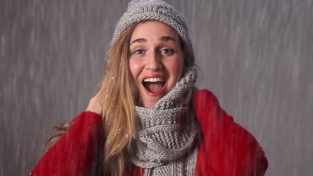 cheerful beautiful girl laughing in snowfall, enjoying holiday season
