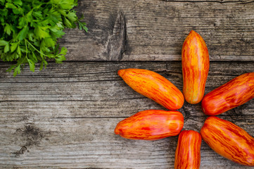 Striped tomato pepper type on a wooden background. Top view. Close-up