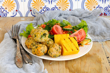 Polenta grill with chicken meatballs and fresh vegetables on a w