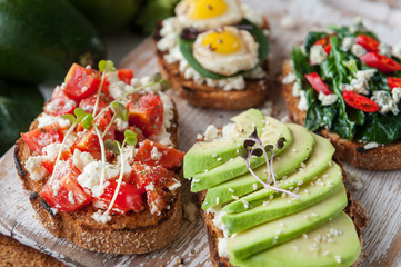 tasty and delicious bruschetta with with vegetables, cheese and micro greens