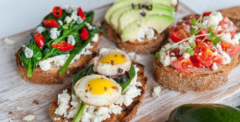 tasty and delicious bruschetta with with vegetables, cheese and micro greens