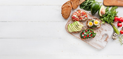 tasty and delicious bruschetta with with vegetables, cheese and micro greens