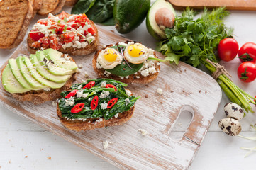 tasty and delicious bruschetta with with vegetables, cheese and micro greens