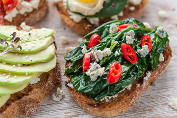 tasty and delicious bruschetta with with vegetables, cheese and micro greens