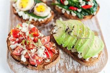 tasty and delicious bruschetta with with vegetables, cheese and micro greens