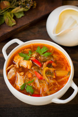Vegetable borscht, traditional Russian and Ukrainian dish. Wooden background. Old rustic table. Top view. Close-up
