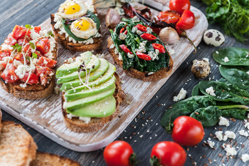 tasty and delicious bruschetta with with vegetables, cheese and micro greens