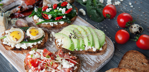 tasty and delicious bruschetta with with vegetables, cheese and micro greens
