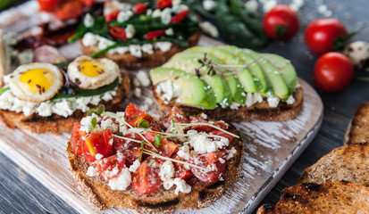 tasty and delicious bruschetta with with vegetables, cheese and micro greens