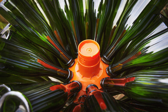 Glass bottles in a bin, green bottles. 