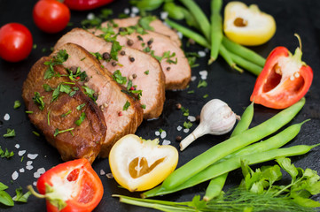 Very tasty cooked beef with spices and vegetables on old table