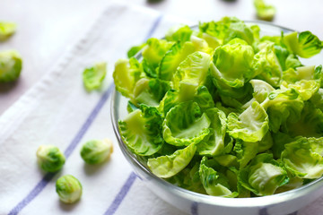 Closeup of Brussels sprouts in glass bowl on napkin