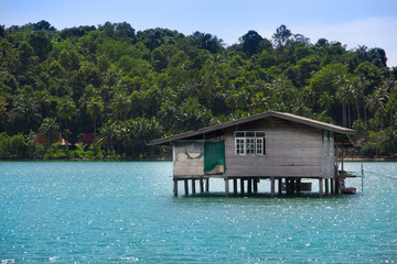 Fototapeta na wymiar Paradise view on house on stilts in tropical country. Travel and vacation concept. Summer in Thailand