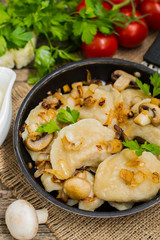 Dumplings with cabbage, fried  mushrooms and cream sauce