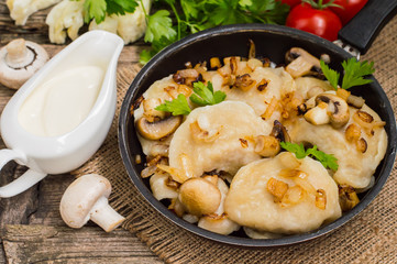 Dumplings with cabbage, fried  mushrooms and cream sauce