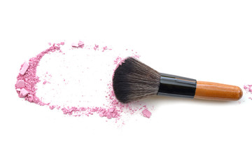 Makeup brush with purple crushed eye shadow, isolated on white.