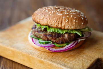 Classic american burger, fast food on wood background