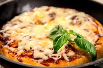 Freshly baked pizza in pan, closeup