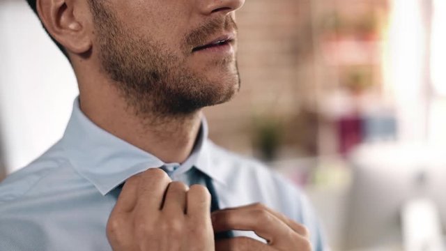 Bussinesman loosing his tie 