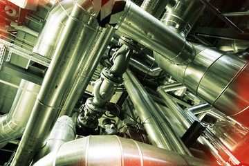 Equipment, cables and piping as found inside of a modern industr