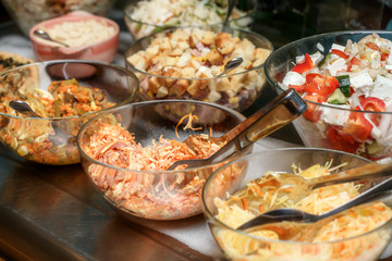 Bowls with various food in self service restaurant