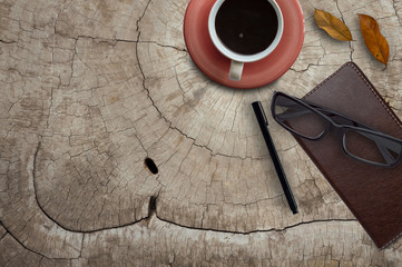 Office desk work with notepad and cup of coffee.