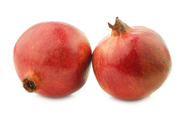 two pomegranate(Punica granatum) on a white background