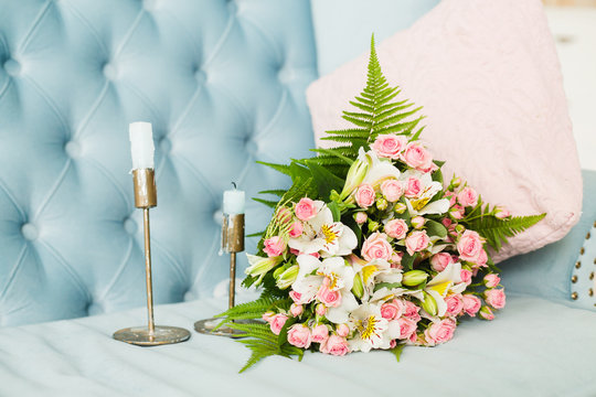  Bridal bouquet. Bridal bouquet on a blue velvet sofa. Candles. Wedding photo concept. Summer wedding. Sensual Wedding Photo. Roses