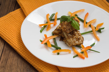 Fish coated in crumbs. Wooden rustic background. Close-up