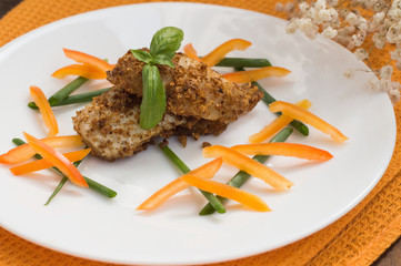 Fish coated in crumbs. Wooden rustic background. Close-up