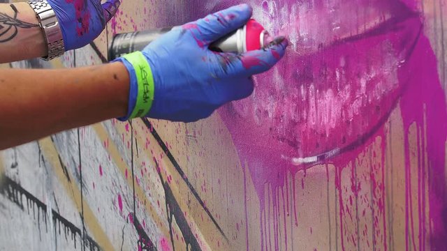 Up fest 2015 Bristol: hand of writer painting on the wall