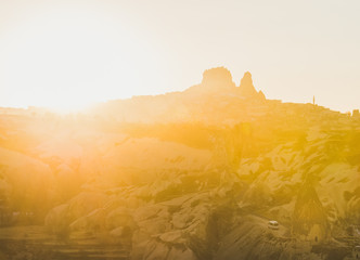 Naklejka premium Colorful sunset over rocks of Goreme and Uchisar castle in Cappadocia region, Central Turkey