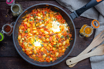 Shakshuka, Traditional Israeli Dish, Scrambled Eggs, Tomatoes, Beans, Paprika and Herbs, Top View