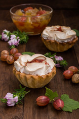 Cake with meringue and pumpkin  apple jam on the background color. Wooden rustic table. Close-up