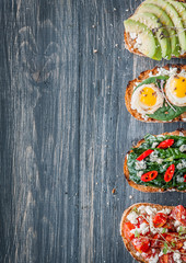 tasty and delicious bruschetta with with vegetables, cheese and micro greens