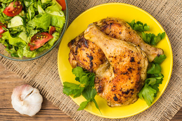 Roasted chicken legs on a wooden background. Top View. Close-up