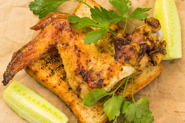 Fried chicken wings on toast. Background paper and food. Close-up. Top view