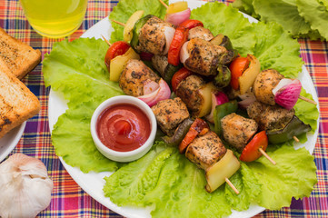 Skewers of chicken and vegetables on wooden . Rural background. Close-up