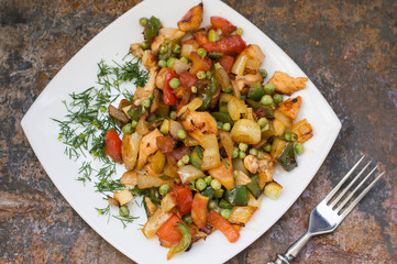 Vegetable Saute and roasted chicken. Rural background. Top view. Close-up