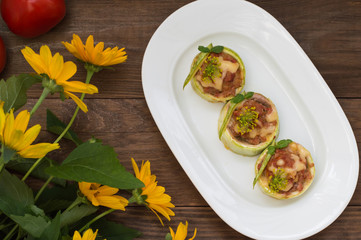 Courgettes stuffed with tomatoes, minced meat, cheese and spices. Wooden background. Top view. Close-up