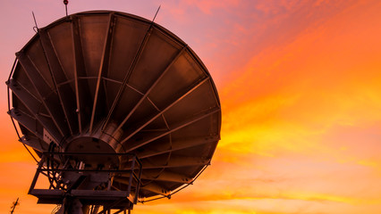 Satellite dishe. Sunset sky background